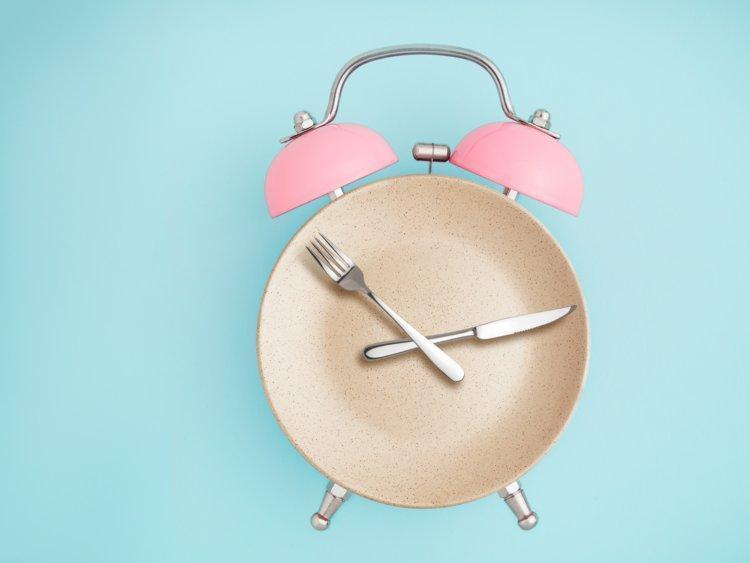 vintage design alarm clock with fork and knife for hands