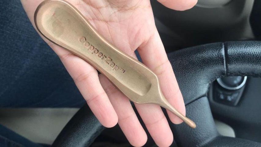 hand holding a Copper Zap inside a car