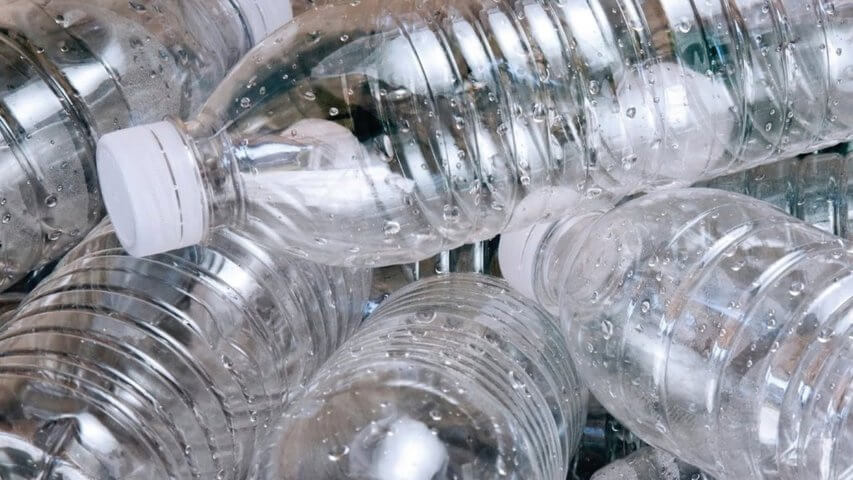 many pieces of plastic water bottles no labels white cap